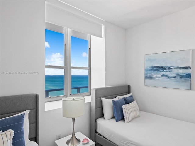 bedroom featuring a water view