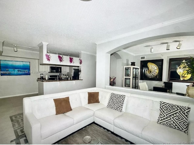 living room with ornamental molding, a textured ceiling, and track lighting