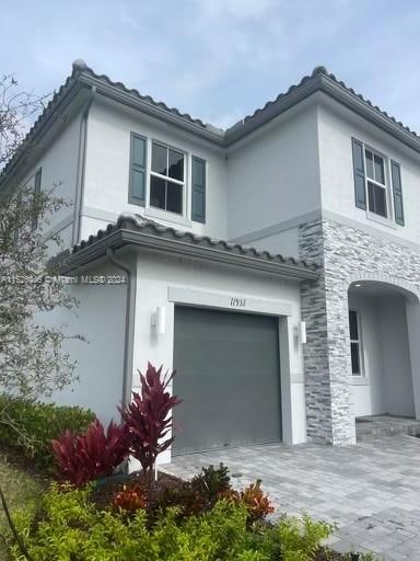 view of side of property with a garage