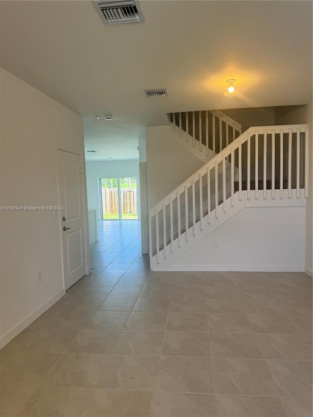 empty room featuring tile patterned floors