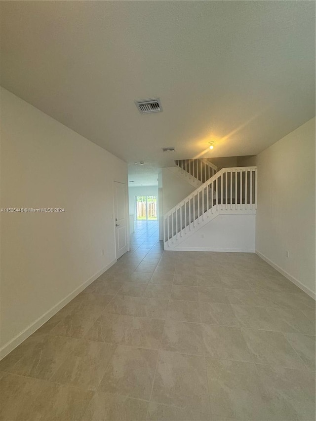 spare room featuring tile patterned flooring