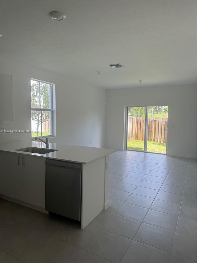 kitchen with a wealth of natural light, light tile patterned flooring, and sink