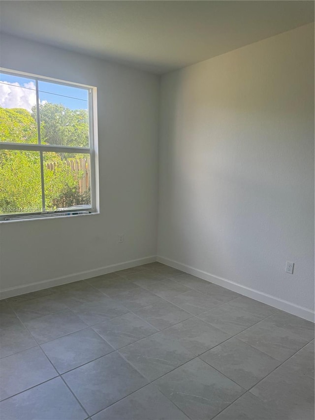 spare room with tile patterned floors