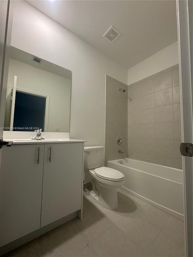 full bathroom with tile patterned flooring, vanity, toilet, and tiled shower / bath