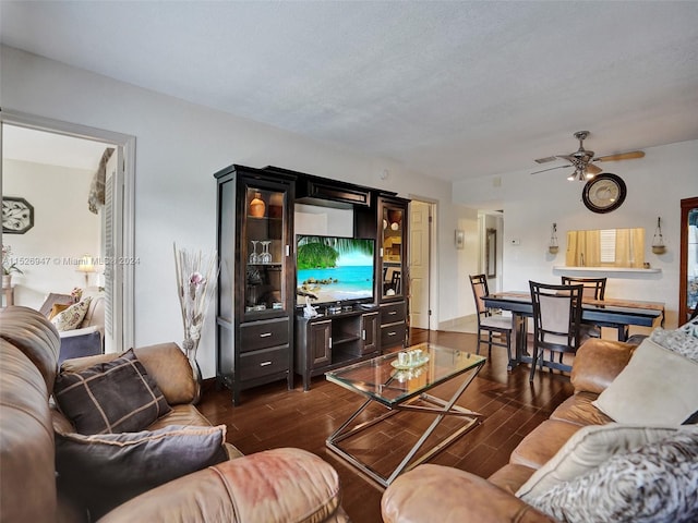 living room featuring dark hardwood / wood-style floors and ceiling fan