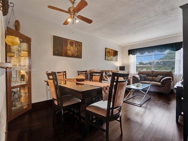 dining room featuring a textured ceiling, dark hardwood / wood-style floors, and ceiling fan