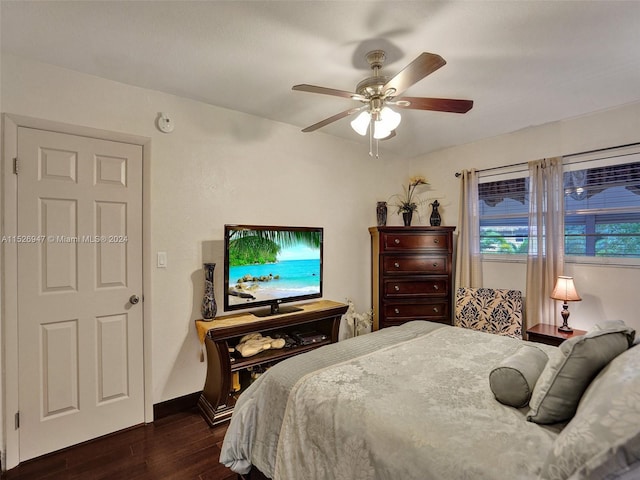 bedroom with ceiling fan and dark wood-type flooring