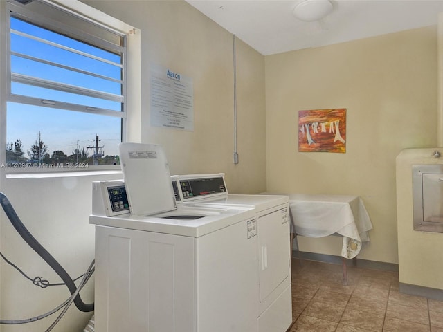 washroom with separate washer and dryer and light tile patterned floors