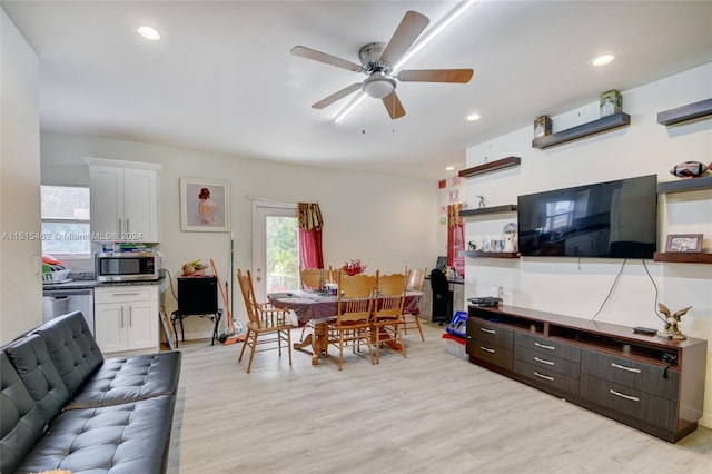 living room featuring light hardwood / wood-style floors and ceiling fan