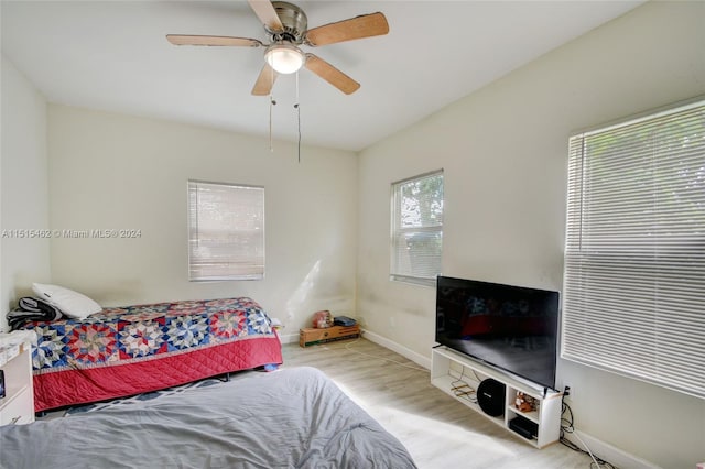 bedroom with light hardwood / wood-style floors and ceiling fan