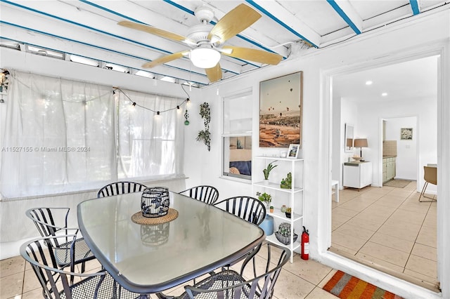 dining space featuring light tile floors and ceiling fan