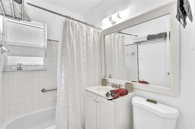 full bathroom featuring toilet, shower / bathtub combination with curtain, and vanity with extensive cabinet space