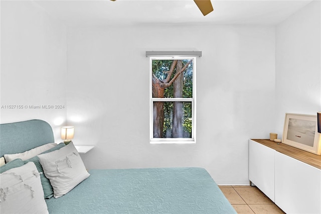 tiled bedroom featuring ceiling fan