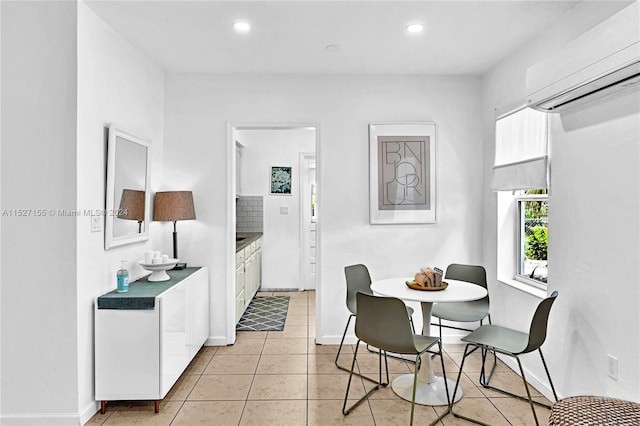 tiled dining room featuring a wall mounted AC