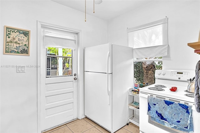 kitchen with white appliances and light tile floors