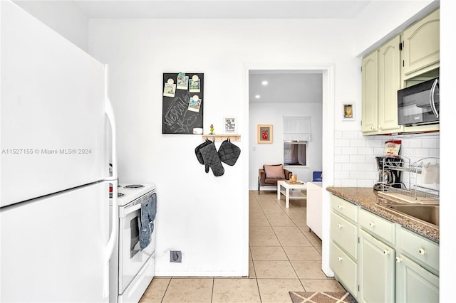 kitchen with white appliances, tasteful backsplash, green cabinets, and light tile flooring