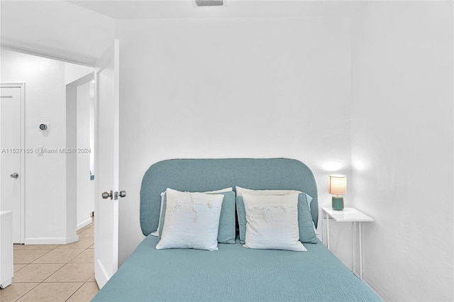 bedroom featuring light tile floors