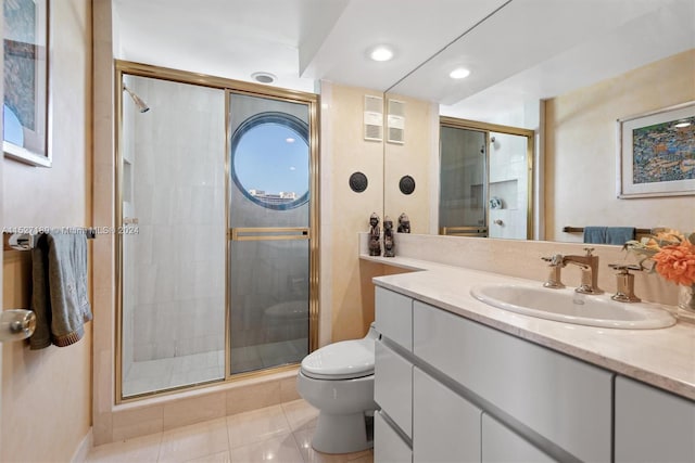 bathroom featuring a shower with door, tile floors, oversized vanity, and toilet