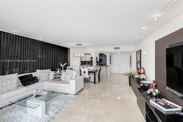 tiled living room featuring track lighting