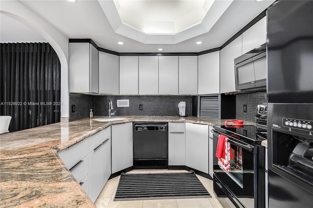 kitchen with tasteful backsplash, black appliances, light tile floors, and light stone countertops