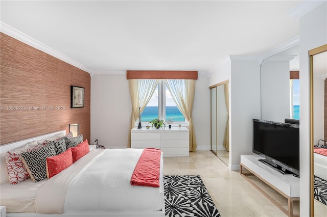 tiled bedroom featuring a water view and crown molding