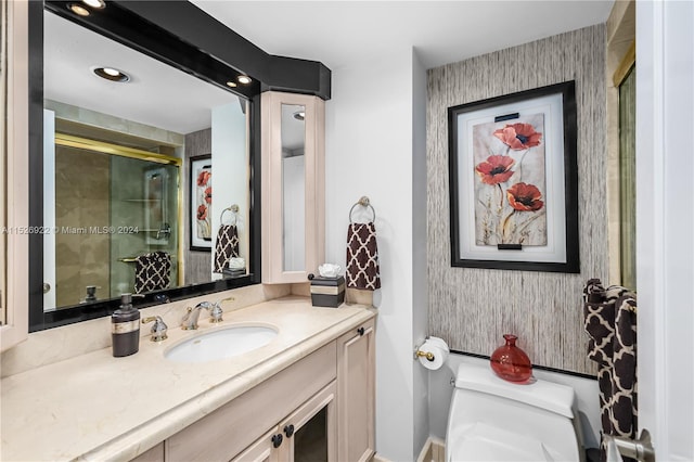 bathroom with vanity with extensive cabinet space and toilet