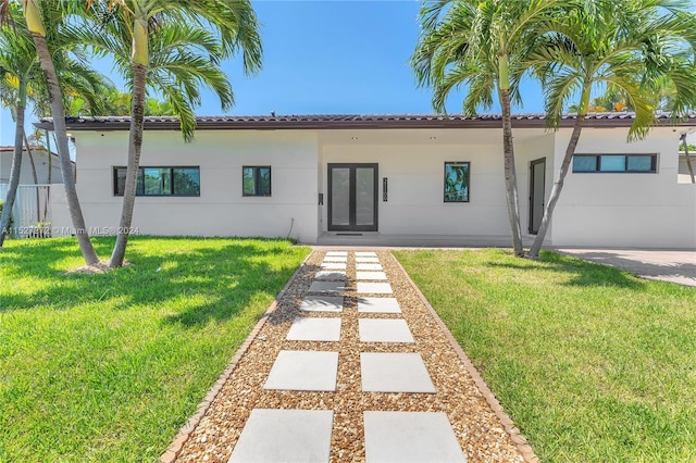 mediterranean / spanish-style home with a front yard