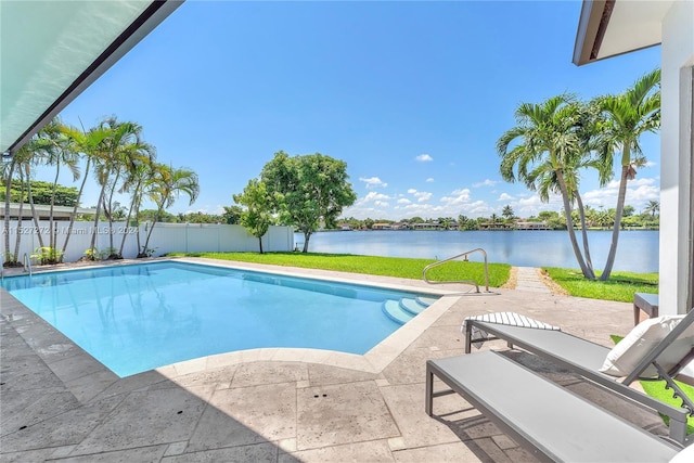 view of swimming pool with a patio area and a water view