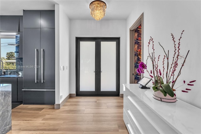 foyer featuring light hardwood / wood-style flooring and french doors