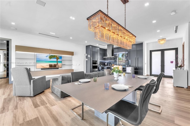 dining area featuring french doors and light hardwood / wood-style flooring