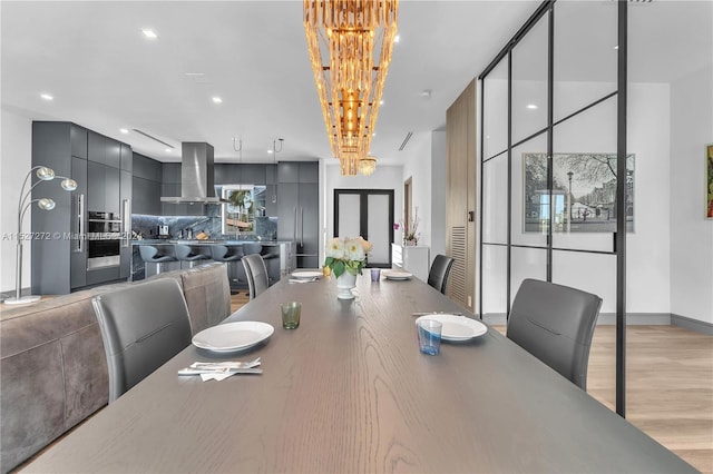 dining room featuring a chandelier and light wood-type flooring