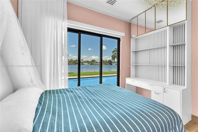 bedroom with a water view and access to outside