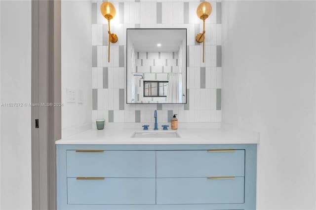 bathroom featuring tasteful backsplash and vanity