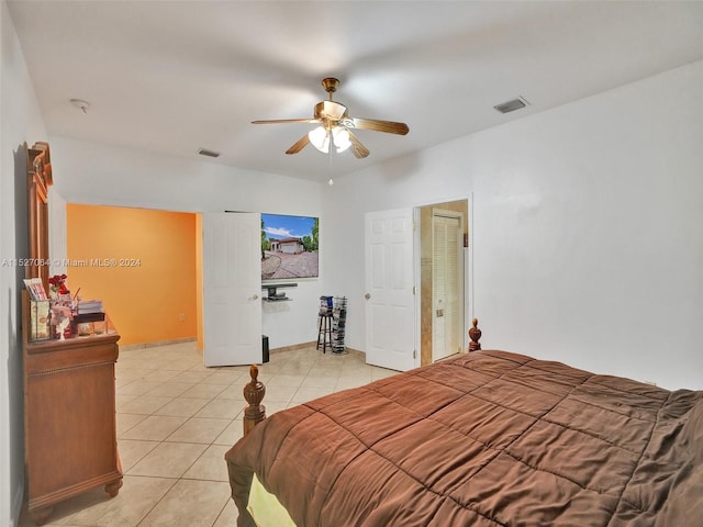 tiled bedroom featuring ceiling fan