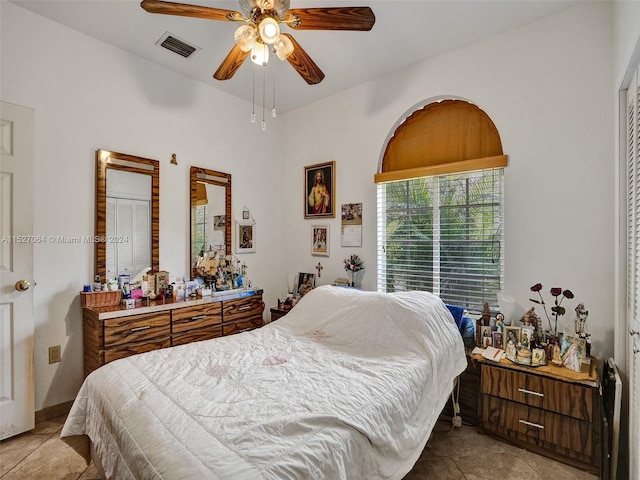 tiled bedroom featuring ceiling fan