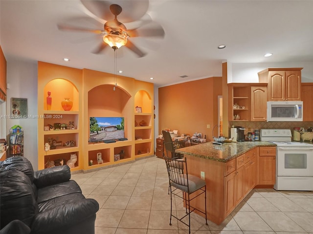 kitchen with ceiling fan, built in features, white appliances, and light tile floors