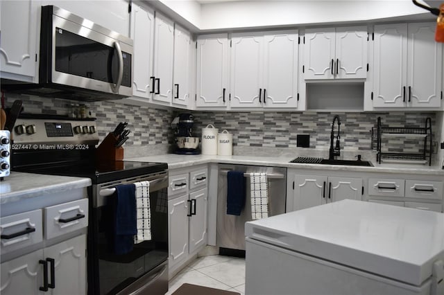 kitchen with white cabinetry, tasteful backsplash, sink, and stainless steel appliances