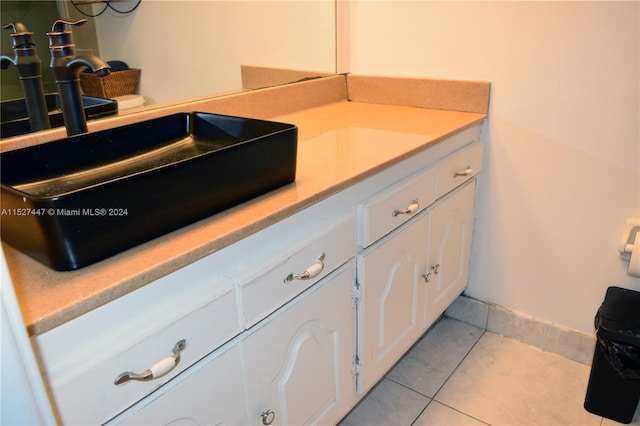 bathroom with tile floors and vanity