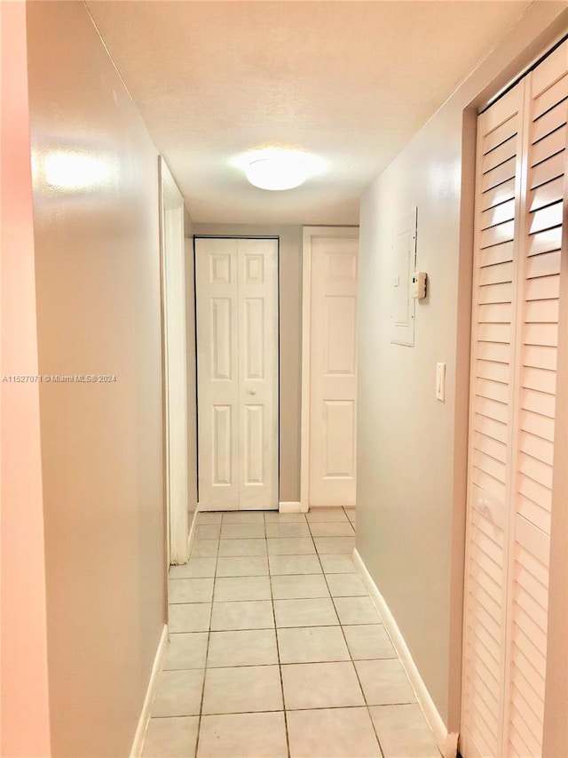 corridor featuring light tile flooring