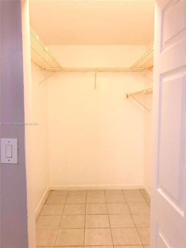 spacious closet with light tile flooring