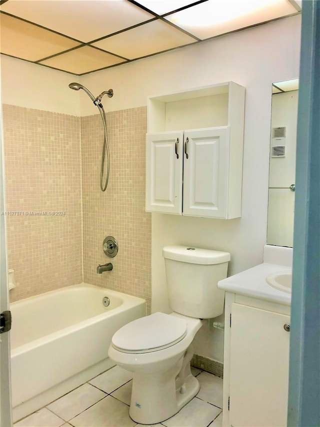 full bathroom featuring tile floors, toilet, vanity, and tiled shower / bath