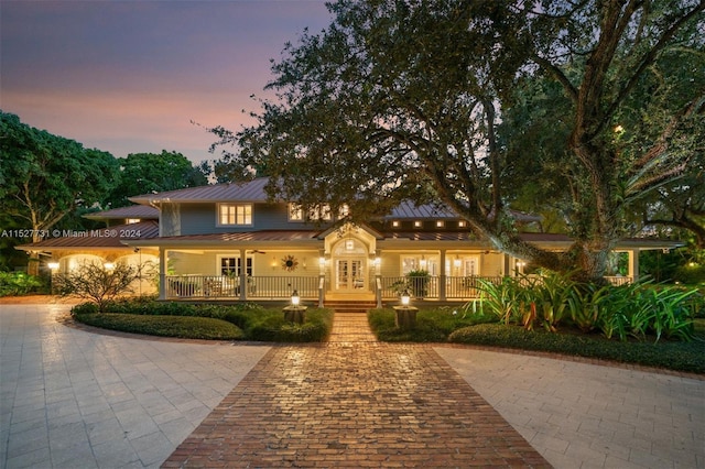 view of front of property with french doors and covered porch