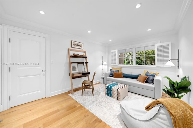 living room with crown molding and light hardwood / wood-style floors