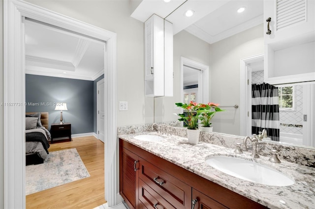 bathroom featuring crown molding, vanity, walk in shower, and hardwood / wood-style flooring