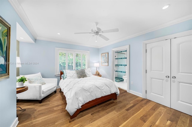 bedroom with ornamental molding, connected bathroom, light hardwood / wood-style floors, and a closet