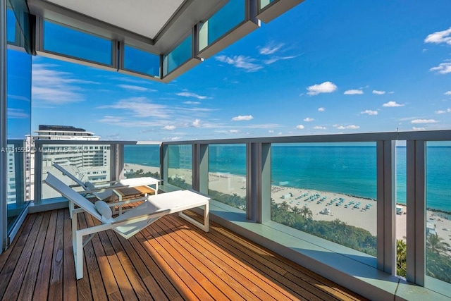 balcony with a beach view and a water view