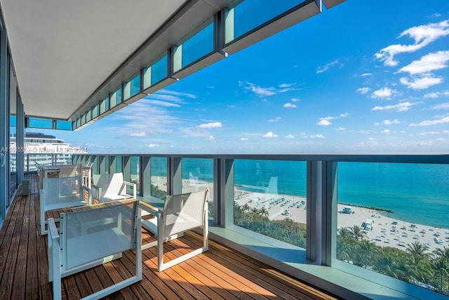 balcony with a beach view and a water view