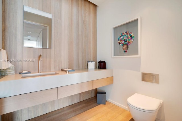 bathroom with toilet, hardwood / wood-style flooring, and vanity