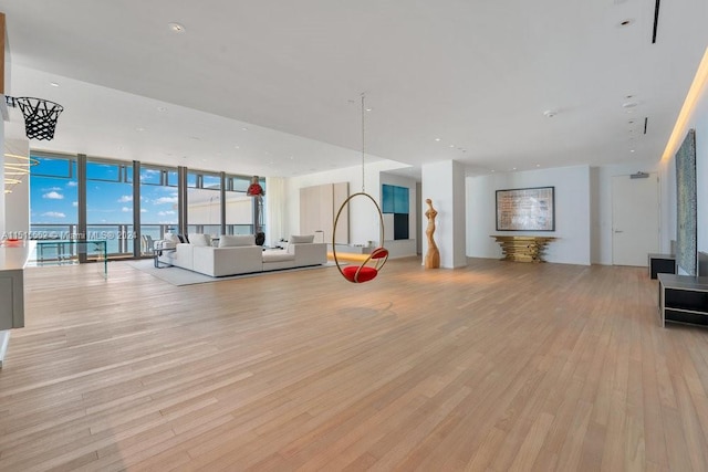 interior space featuring expansive windows and light hardwood / wood-style floors