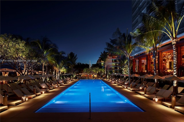 pool at twilight featuring a patio